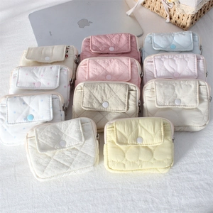 Quilted mini wallets in macaron colors including heart patterns and metal zippers