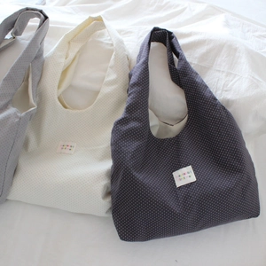 Detailed close-up of three dotted tote bags featuring colorful mayrabbit fabric labels