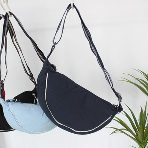 Close-up of lightweight crescent dumpling bags with adjustable straps and zip closures