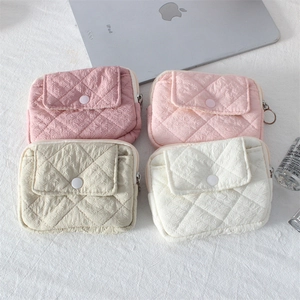 Quilted mini pouches in pink, beige, and white colors with snap buttons and zippers