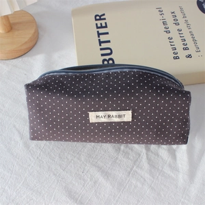 Close-up of May Rabbit polka dot pencil case with fabric label and blue zipper