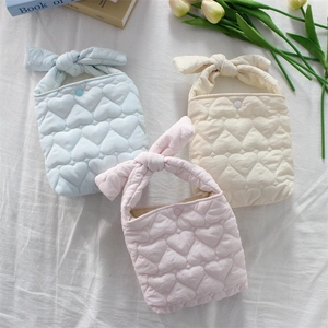 Chic quilted heart tote bags with bow handles in blue, pink, and white soft fabric