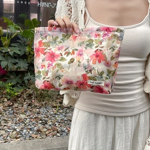 Detailed texture of cotton floral makeup bag with elegant MAY RABBIT brand label