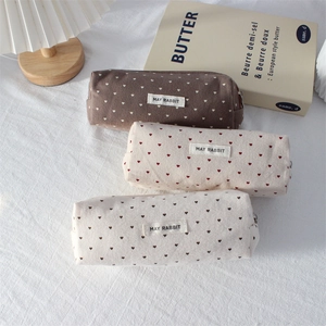 Polka dot heart canvas pencil cases in brown, pink, and white with zipper closure