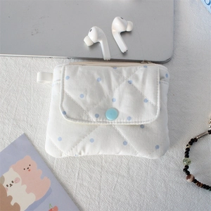 Detailed shot of quilted polka dot cotton pouch with snap pocket on a tidy desktop