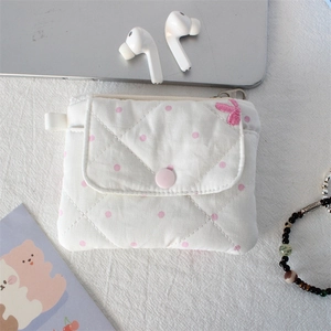 Detailed view of quilted cotton coin purse with pink polka dots and bow embroidery