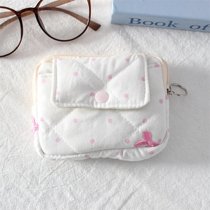 Detailed view of quilted cotton mini pouch with pink polka dots and side zipper