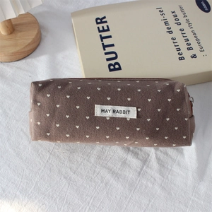Detail of the May Rabbit polka dot heart pencil case with zipper and woven label