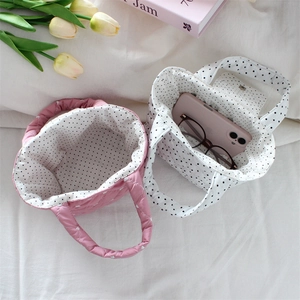Close-up of quilted handheld bags with polka dot lining for daily commuter storage