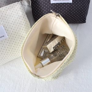 Close-up of polka dot canvas makeup pouch interior showing high storage capacity