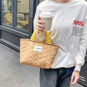 Quilted heart pattern tote bag in khaki with bright yellow handles for daily fashion