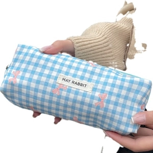 Blue gingham makeup bag with pink bow patterns and a central rabbit logo label