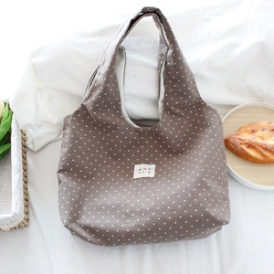 Detail of soft fabric tote bag with white polka dots and mayrabbit woven label