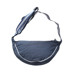 Navy blue canvas half-moon crossbody bag with striped shoulder strap and white piping