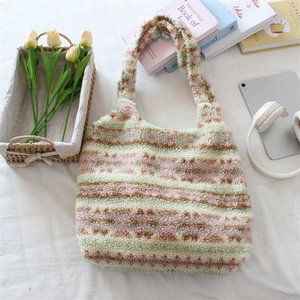 Flat lay of colorful striped plush tote bag with tablet, headphones and tulips