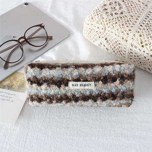 Detail shot of plush wavy striped pencil case with soft faux fur and May Rabbit label