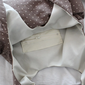 Close-up of heart print tote bag interior featuring an inner zipper storage pocket