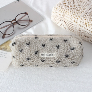 Close-up of soft plush pencil case with heart print and durable zipper detail