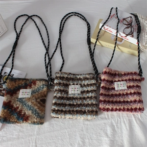 Fleece crossbody bag with geometric prints and thick cord strap in multiple colors