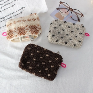Macro view showing soft sherpa texture and zipper details of vintage storage pouches