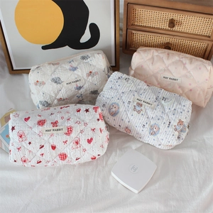 Quilted cotton cosmetic bags with cute cartoon prints in a set of four soft pouches