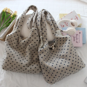 Ethnic plush heart-print tote bag set with wide shoulder strap on aesthetic background