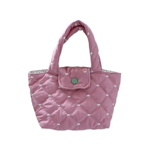 Pink quilted tote bag with heart embroidery and a contrast green round snap closure