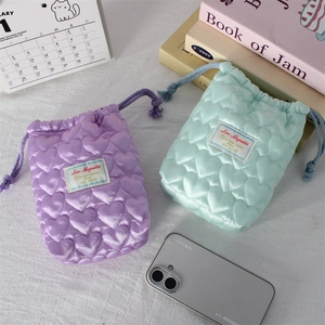 Quilted heart camera storage pouch in purple and mint green with drawstring closure