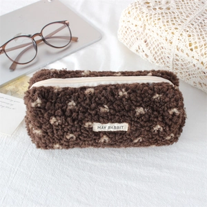 Close-up of soft brown plush pencil case with zipper and MAY RABBIT label on fabric