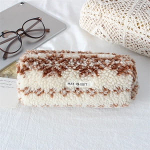 Detailed macro view of plush teddy fleece texture and checkerboard pattern pencil case