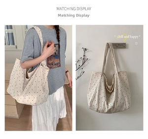 Detailed views showing a cream canvas polka dot tote bag being worn and hung on a wall