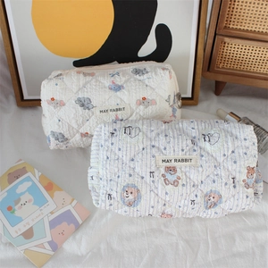 Detail of quilted cotton cosmetic bags with cartoon elephant and bear prints by May Rabbit