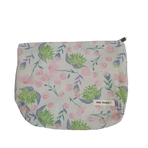 Floral makeup bag with pink flowers and May Rabbit label on a grey background