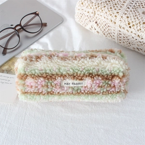 Close-up of soft plush pencil case with colorful stripes and secure zipper closure