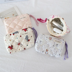 Close-up of quilted cotton cosmetic bags with cute rabbit and puppy patterns