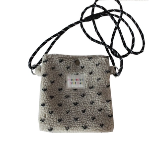Plush polka dot crossbody bag in beige fleece with woven strap for casual daily use
