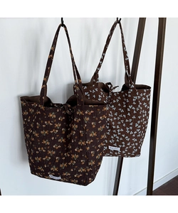 Detail of floral tote bags showing seersucker fabric texture and Magic pocket label