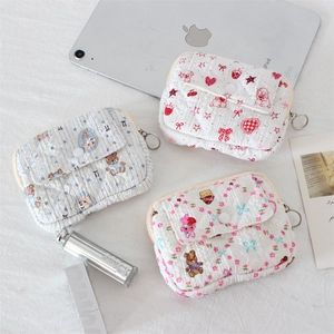 Quilted pouch with front flap and round button for coins and small essentials