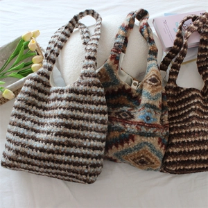 Detailed view of thick knit tote bags with ethnic prints and striped patterns