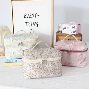 Three elegant jacquard cosmetic bags with floral embroidery and top handles