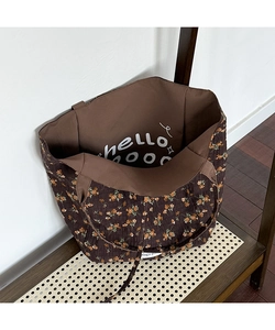 Detail of floral tote bag interior with hello ooo text and soft brown fabric lining