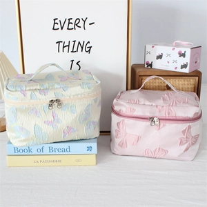 Floral jacquard travel makeup bag with top handle and dual zipper in pink and white
