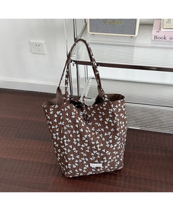 Close-up of floral pattern canvas tote bag with Magic Pocket label on wooden floor