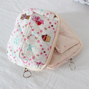 Close-up of quilted floral and cartoon bear patterns on soft cotton zipper coin purses