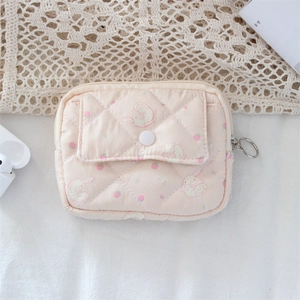 Detailed view of pink quilted storage pouch with rabbit strawberry print and silver zipper