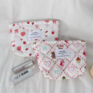 Quilted floral cosmetic bag with cartoon rabbit and bear patterns on white fabric