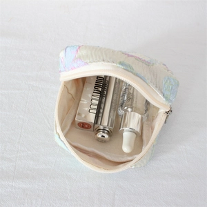 Detail of floral embroidery cosmetic pouch showing large capacity for lipsticks and makeup