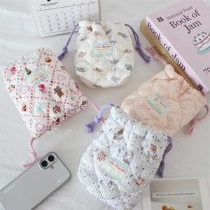 Quilted cotton drawstring pouches in floral and animal patterns for camera storage