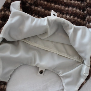 Macro detail of plush floral tote bag showing satin lining and secure snap button closure