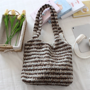 Close-up of plush striped tote bag with soft texture and laptop in lifestyle setting